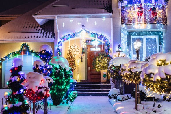 Image of Christmas lights and decor on stucco home